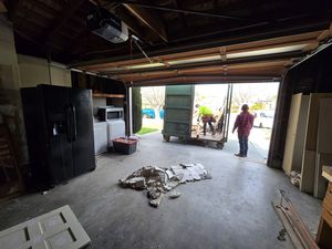 Loading Trash into Dumpster