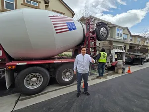 Project Manager Posing Next to Concrete Mixer