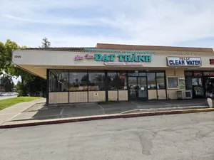 The exterior of Com Tam Dat Thanh, located at 1055 Tully Rd, San Jose, CA, featuring the restaurant's sign and a nearby business with a clear view of the surrounding area.