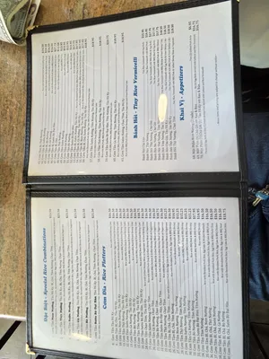 The menu at Com Tam Dat Thanh, showing a variety of rice dishes and combinations, with prices listed for each item. The menu includes popular Vietnamese dishes like Com Tam, grilled meats, and rice platters.