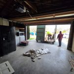 Loading Trash into Dumpster