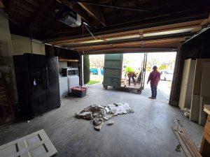 Loading Trash into Dumpster