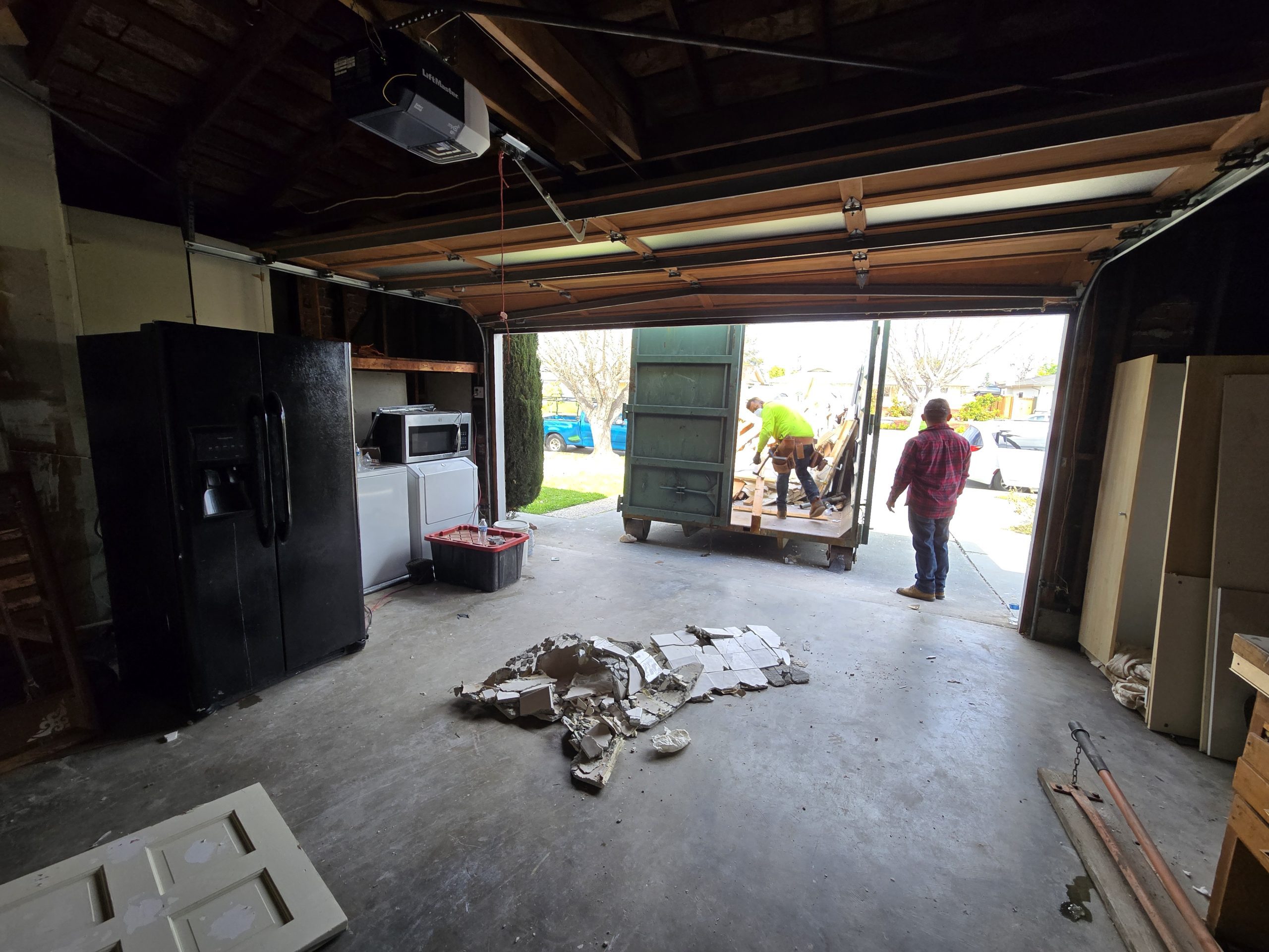 Loading Trash into Dumpster