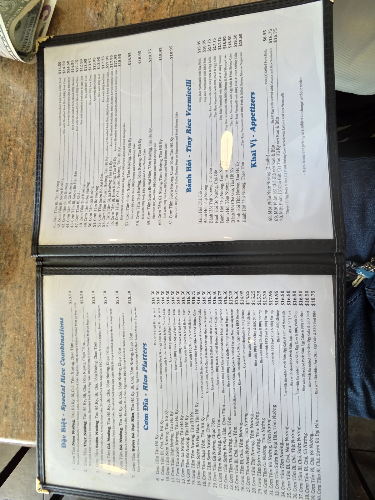 The menu at Com Tam Dat Thanh, showing a variety of rice dishes and combinations, with prices listed for each item. The menu includes popular Vietnamese dishes like Com Tam, grilled meats, and rice platters.