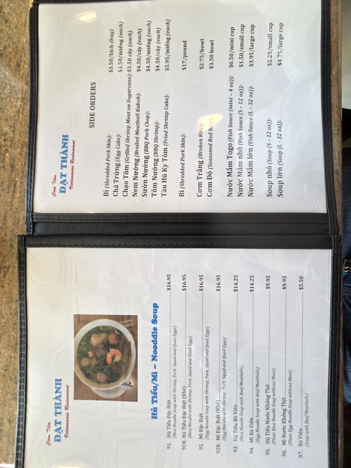Another close-up of the menu, displaying side orders, noodle soups, and a variety of beverages, along with their prices.