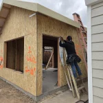 Framing Setup – Workers Fine-Tuning the Structure Before Final Inspection